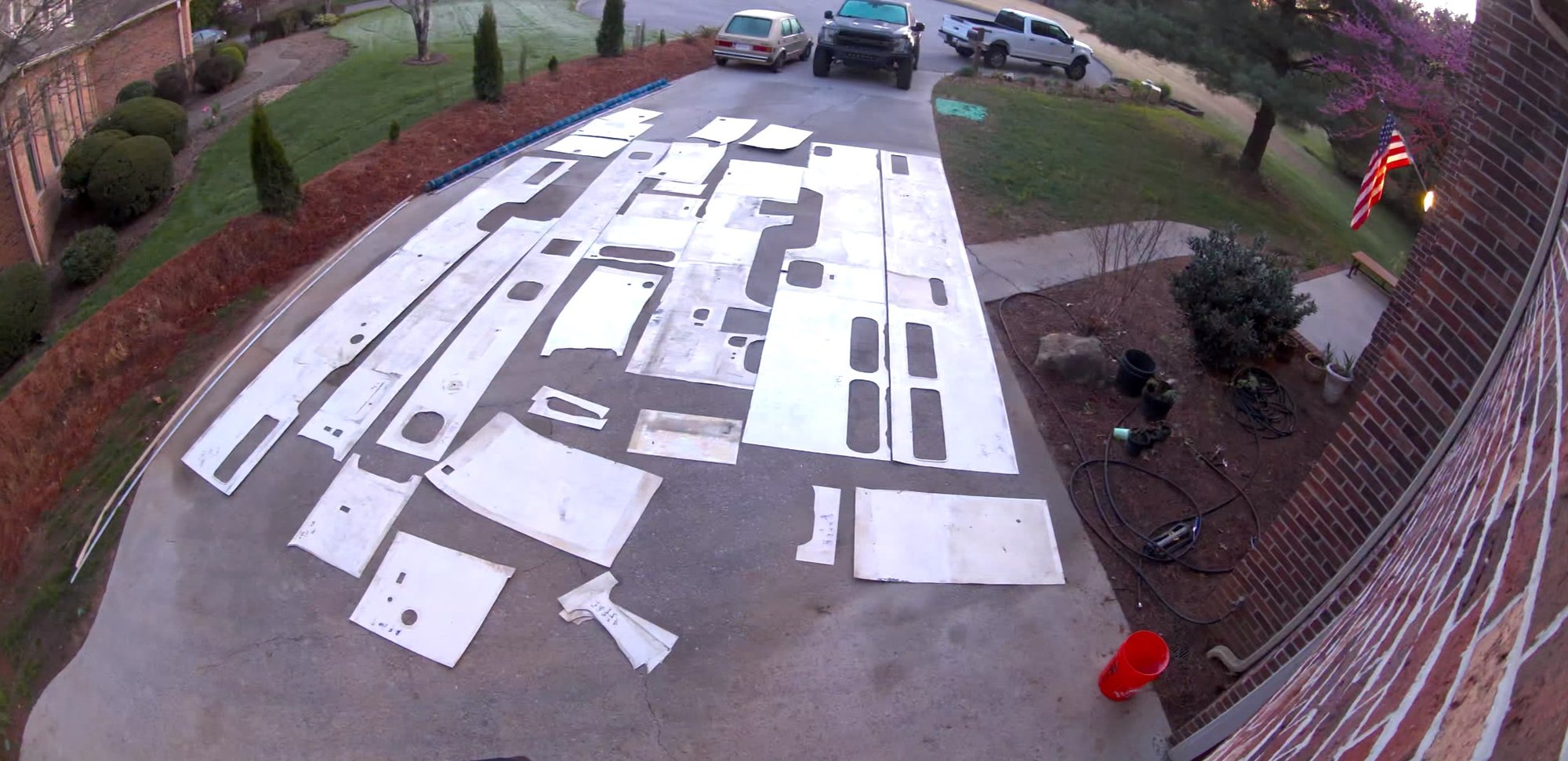 Interior paneling pulled out and laid across the driveway to be power washed — decades of grime.