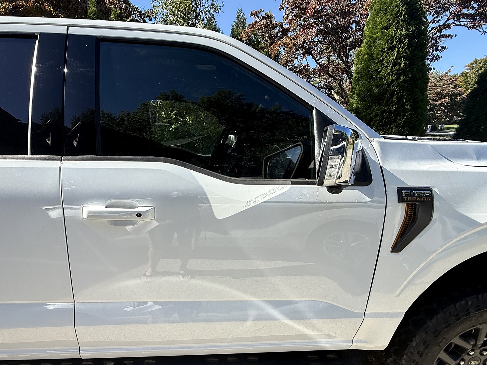 Ford (OEM, Motorcraft) via American Fleet MD Front door shells, left and right, Oxford White, new take-off — Passenger side hung, next to the wrapped temporary fender.