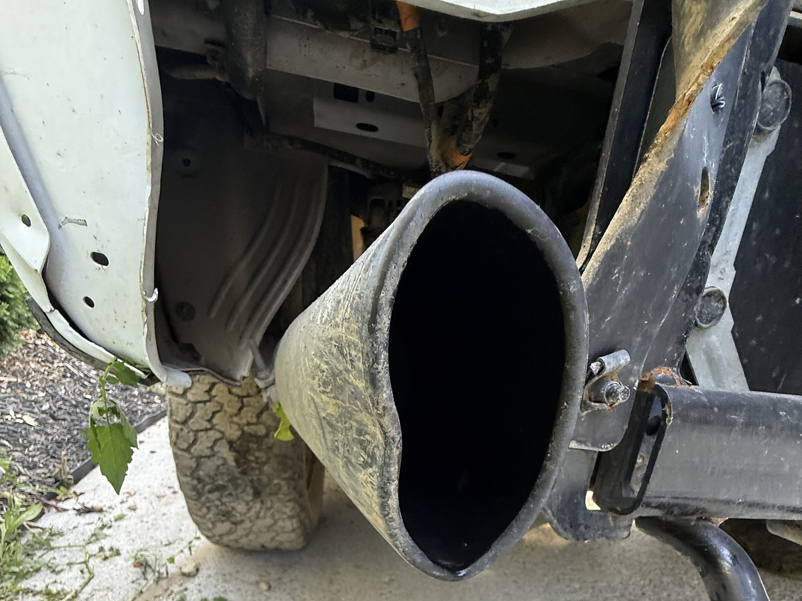 Vurkcy Bolt-on exhaust tip, 3 in inlet, 4 in outlet, 12 in long — The tip it replaced: the original, crushed in the rear impact.