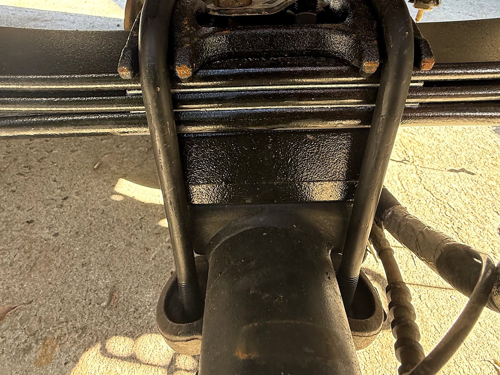 Ford (OEM pattern, used) OEM-style 2.25 in axle lift blocks, correct angle — Replacement block in place, with the U-bolts fitted.