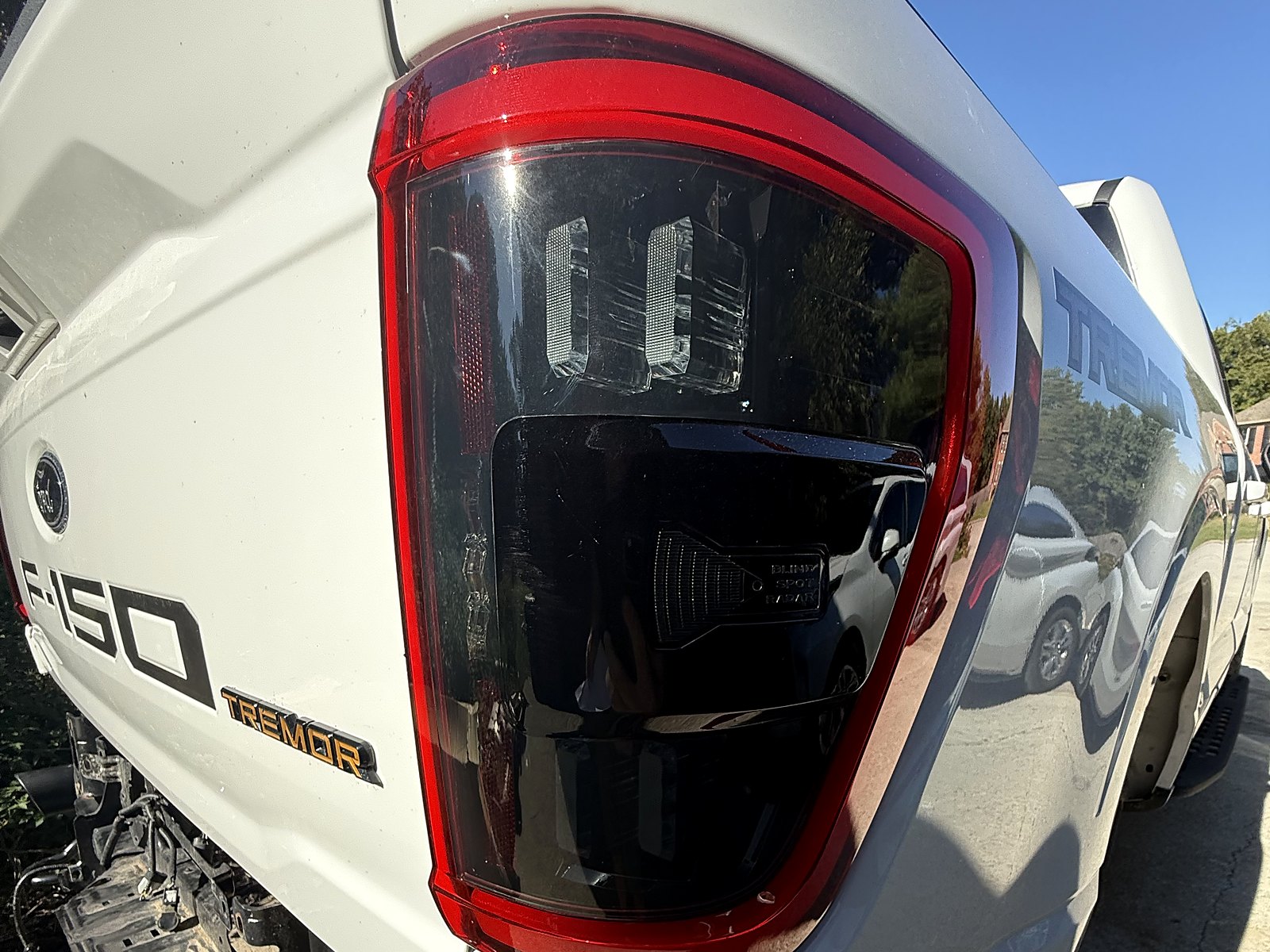 Morimoto XB red-lens taillights — Passenger side, on the truck.