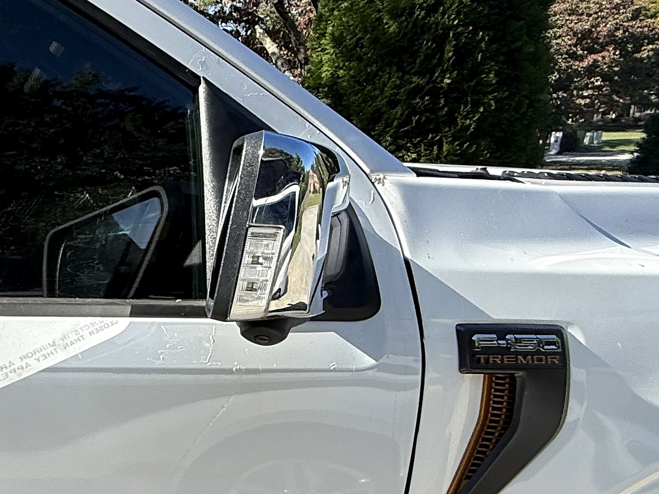 Ford (OEM) Passenger exterior mirror, 402A feature set, power-fold with side camera — On the truck with its chrome cap, until the white covers arrive.